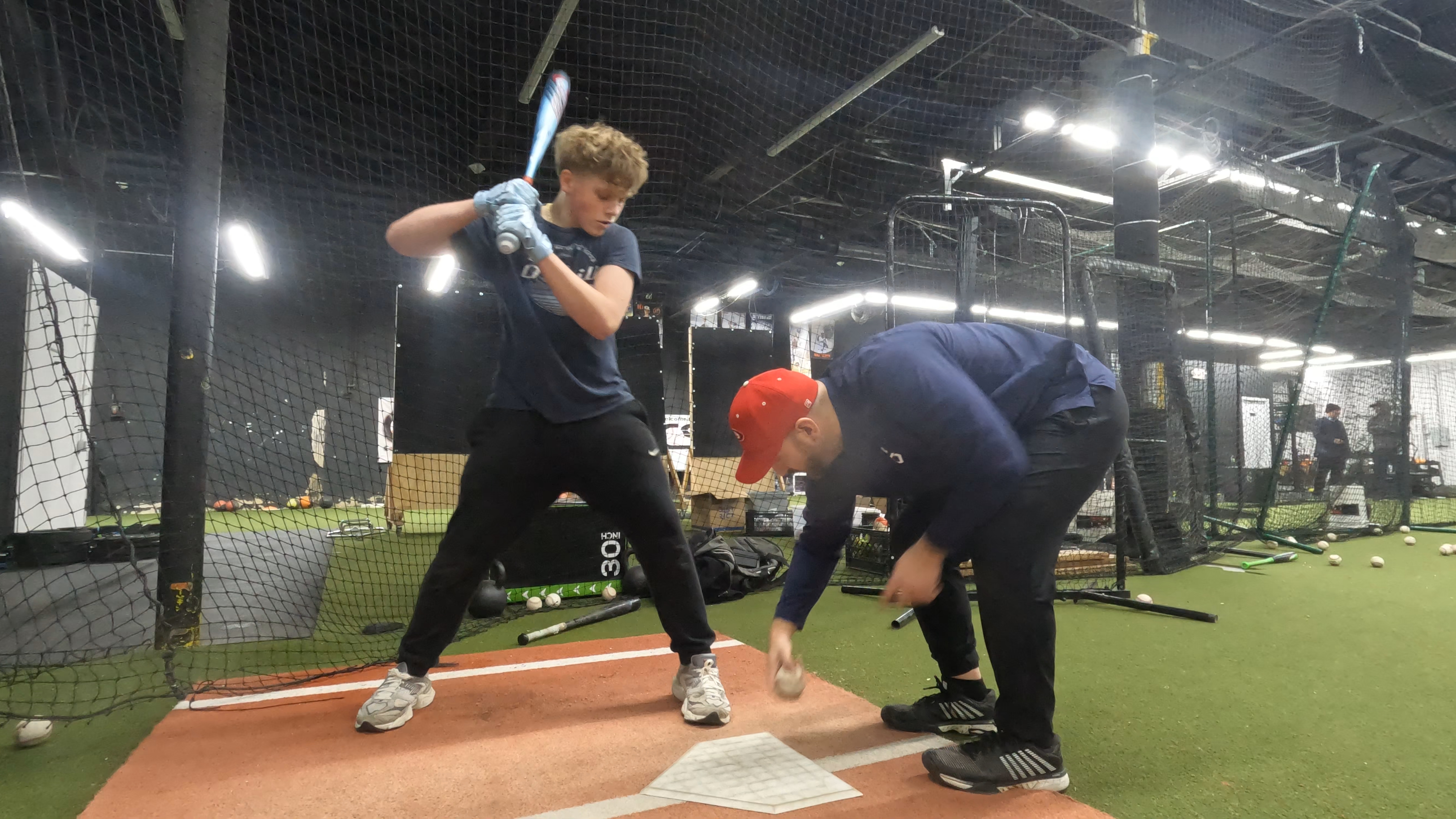 Coach Steve positioning a young hitter's lower half and footwork at home plate